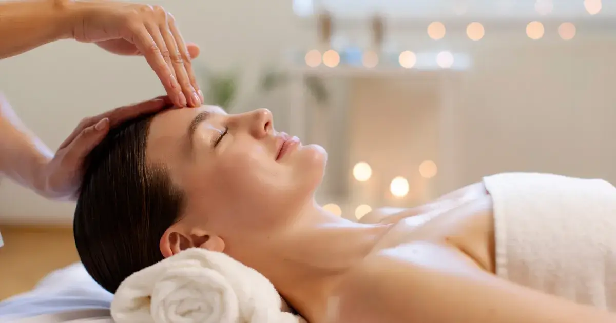 A professional performing a Japanese head spa massage on a woman’s scalp in Guntersville, AL