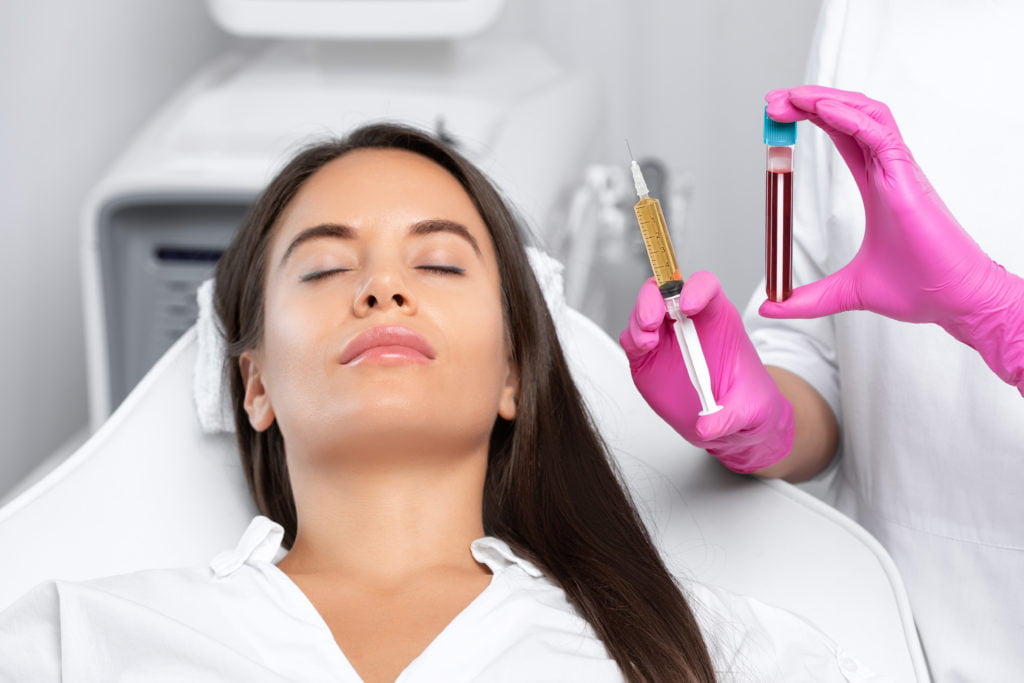 A Lady with closed eyes and doctor holding injection | Get PRP treatment at Cultivated Beauty Aesthetic in Gunterville, AL
