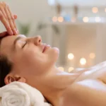 A professional performing a Japanese head spa massage on a woman’s scalp in Guntersville, AL